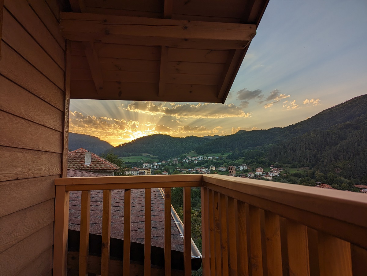 wood balcony mountain view of sunset