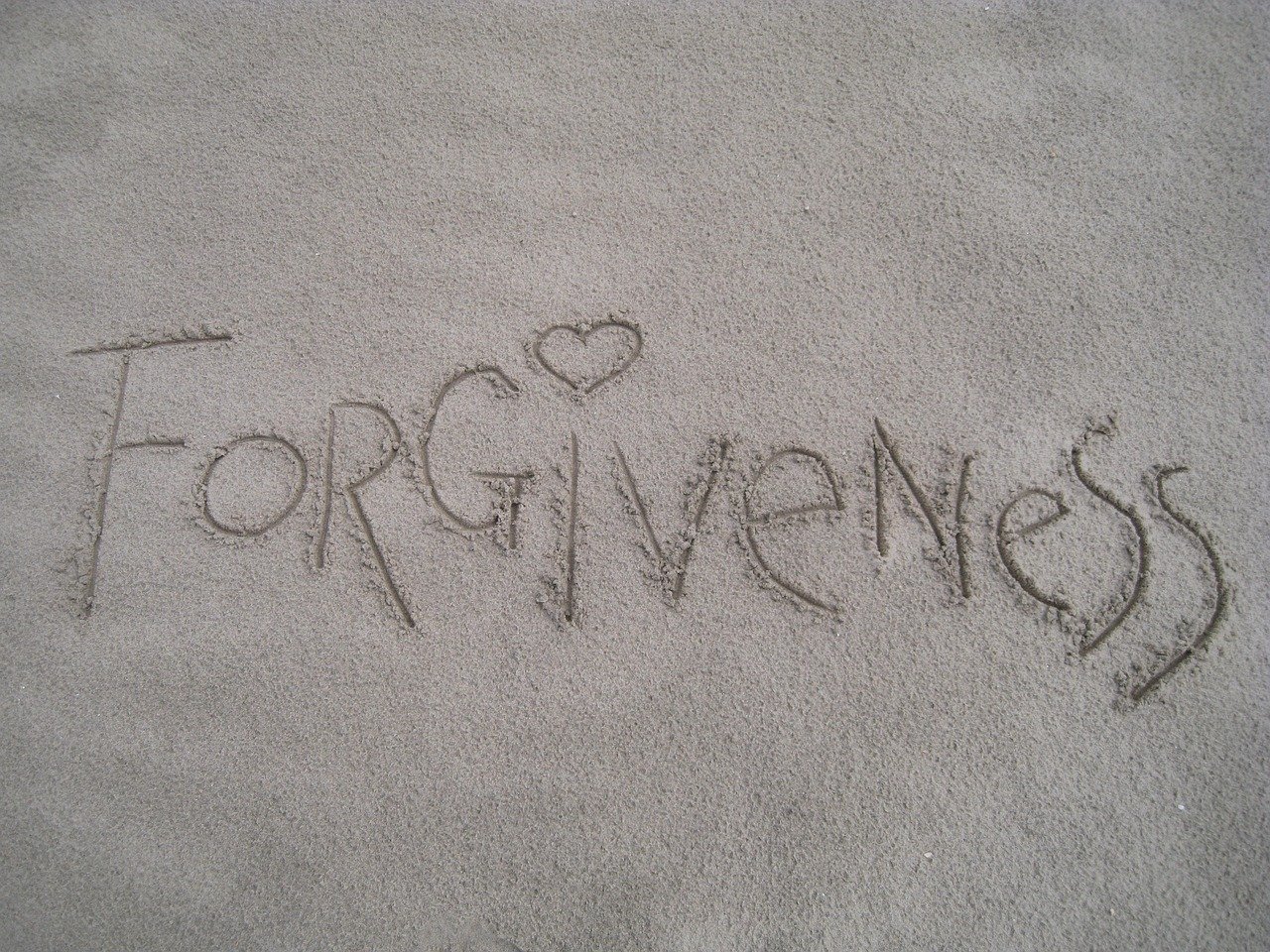forgiveness written in sand