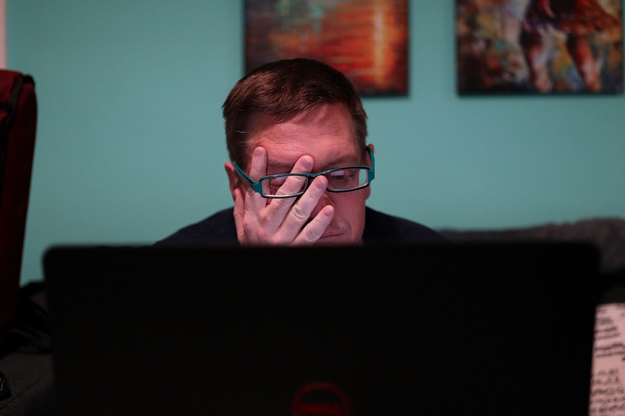 man laptop glasses stress