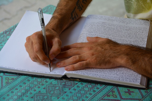 man journaling hands pen